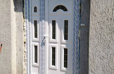 Dvokrilna ulazna vrata u beloj boji sa ukrasnim panelima B-406 i B-986.